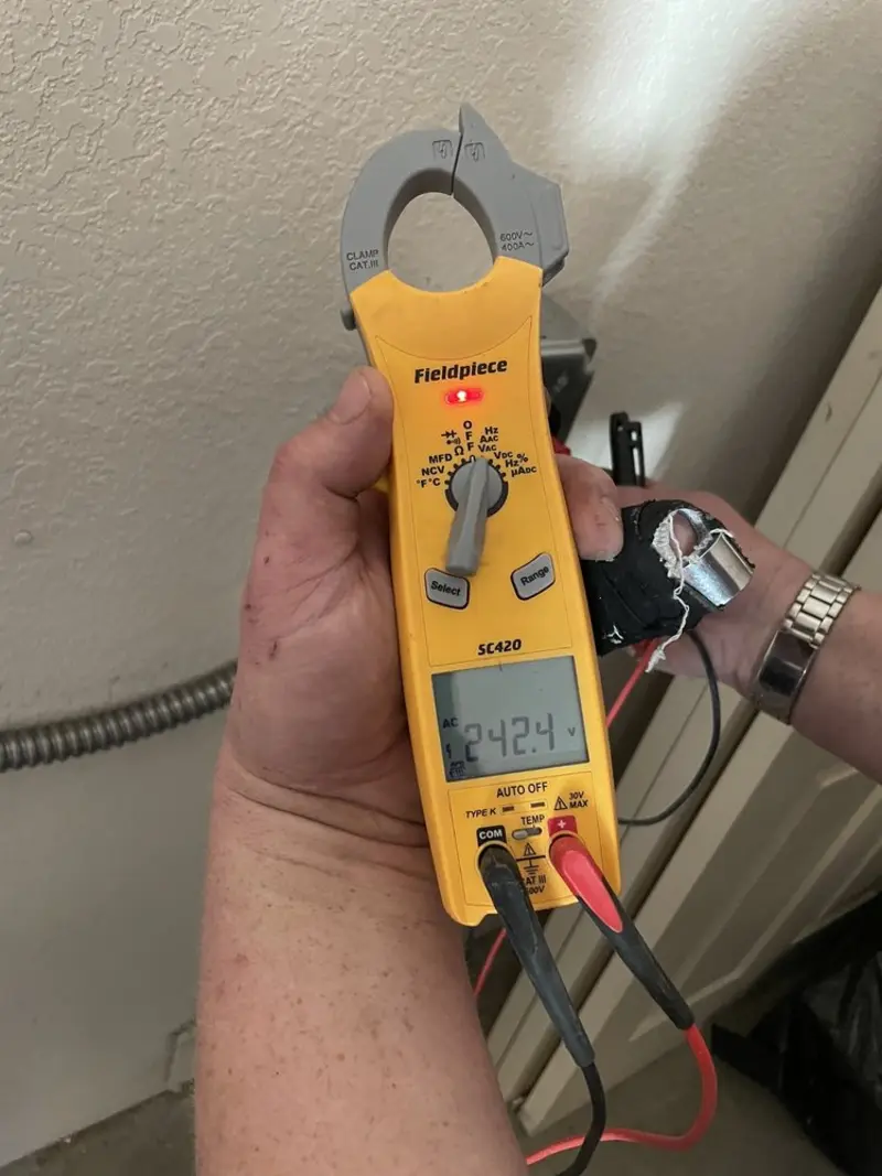 Voltage testing with clamp meter during Outlet Installation in Fort Gratiot